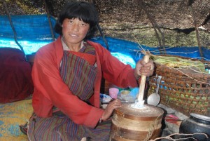 A Bjob woman churns butter inside her Bja (tent) in the higher mountains of Bhutan.