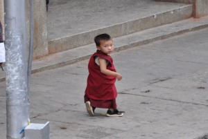 A young monk turns to the camera on the streets of Thimphu.